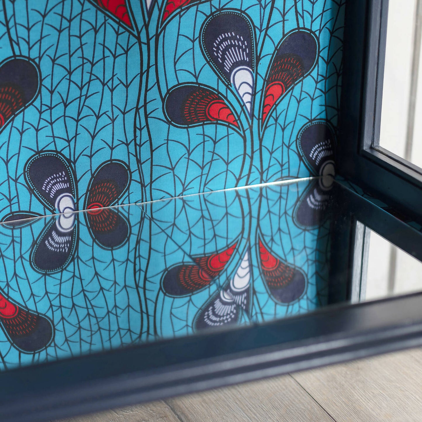 Blue Art Deco drinks cabinet, distinguished by its heart shape and decoupage featuring an African-inspired peacock feather fabric. Sold, commission available.