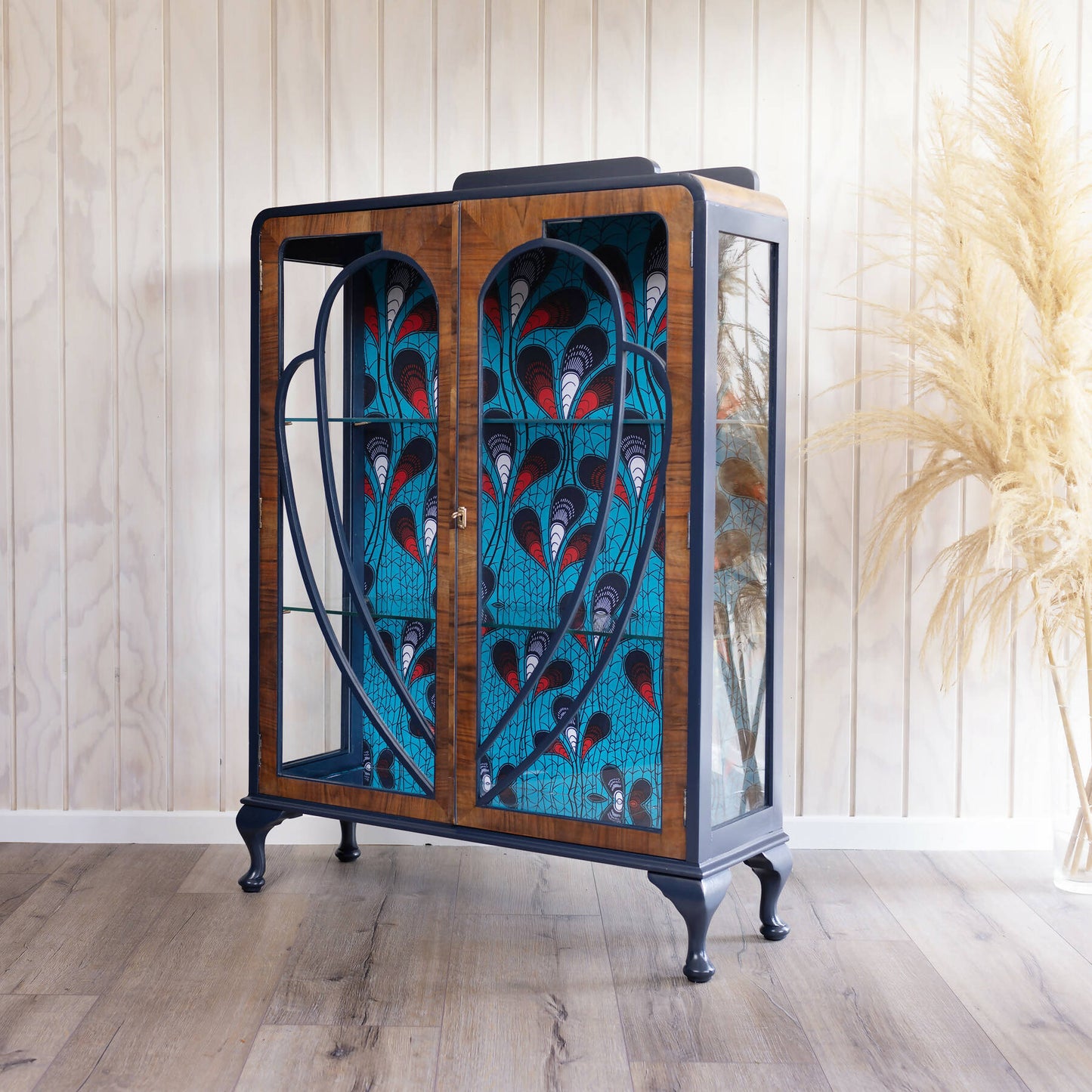 Blue Art Deco drinks cabinet, distinguished by its heart shape and decoupage featuring an African-inspired peacock feather fabric. Sold, commission available.