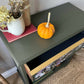 Vintage bookcase painted green with floral detail