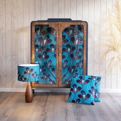 Blue Art Deco drinks cabinet, distinguished by its heart shape and decoupage featuring an African-inspired peacock feather fabric. Sold, commission available.