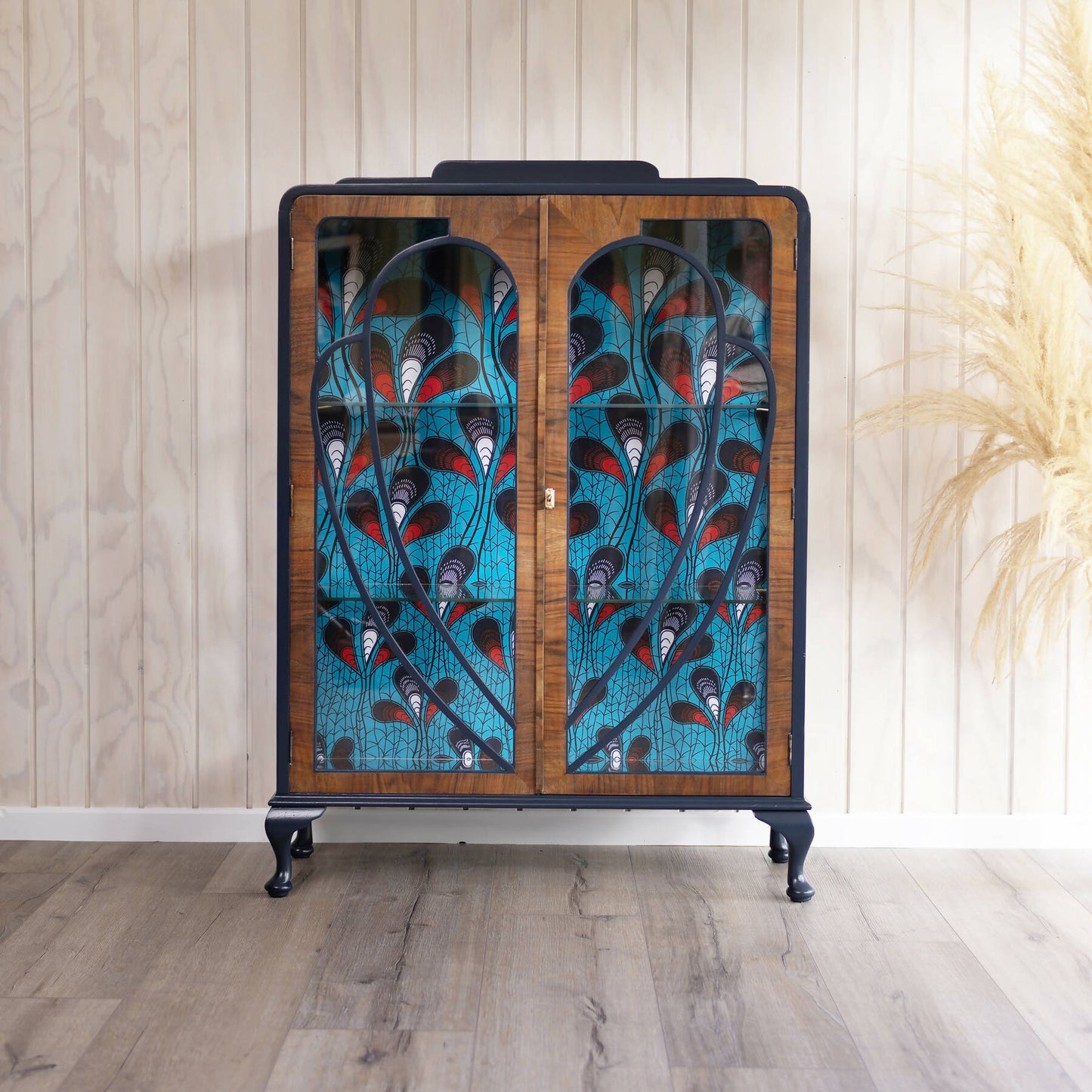 Blue Art Deco drinks cabinet, distinguished by its heart shape and decoupage featuring an African-inspired peacock feather fabric. Sold, commission available.