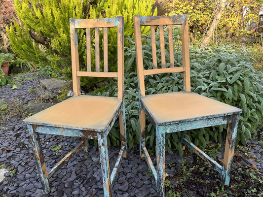 Two pumpkin and copper dining chairs