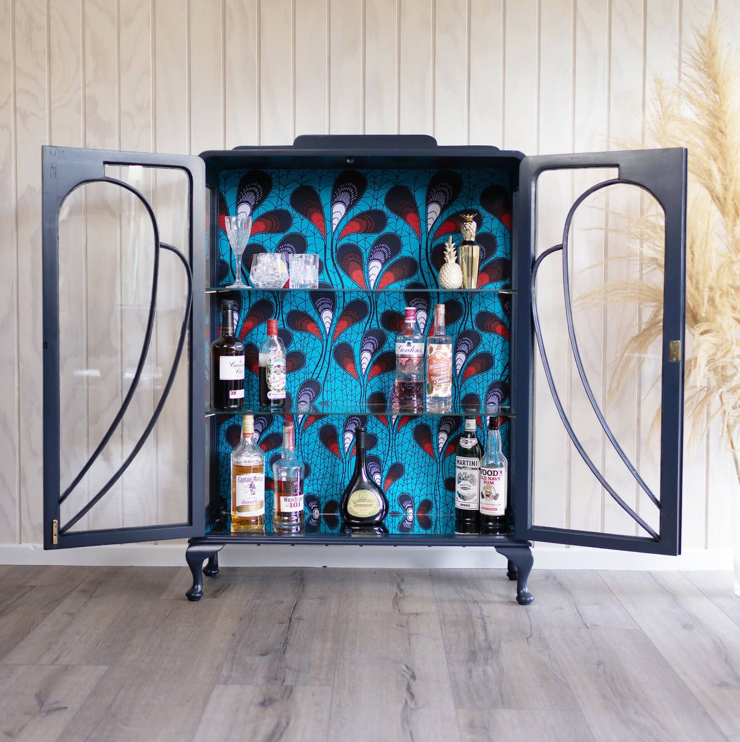 Blue Art Deco drinks cabinet, distinguished by its heart shape and decoupage featuring an African-inspired peacock feather fabric. Sold, commission available.